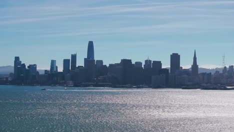 telephoto drone shot flying in towards downtown san francisco on a sunny day