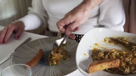 slowmotion shot of spanish food being dished out and served onto a plate