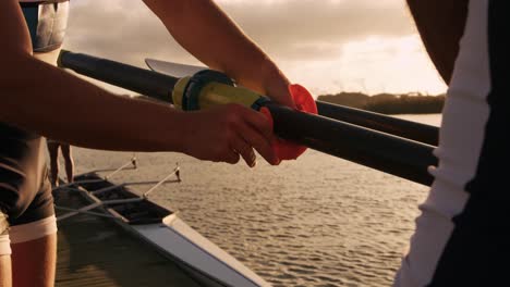 male rowers fixing the oar