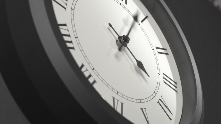 Latin Clock Face in Time Lapse on Dark Grey Wall