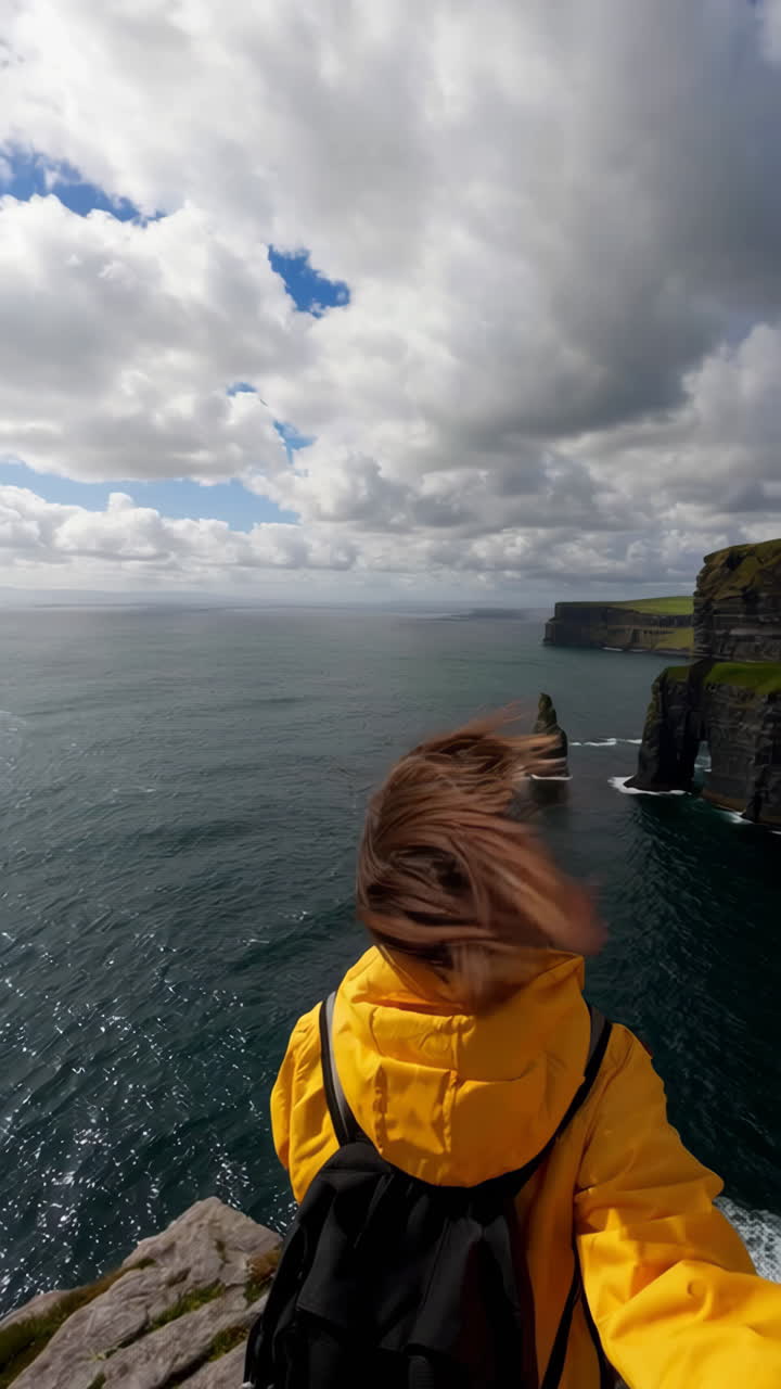 Woman exploring the iconic Cliffs of Moher in Ireland