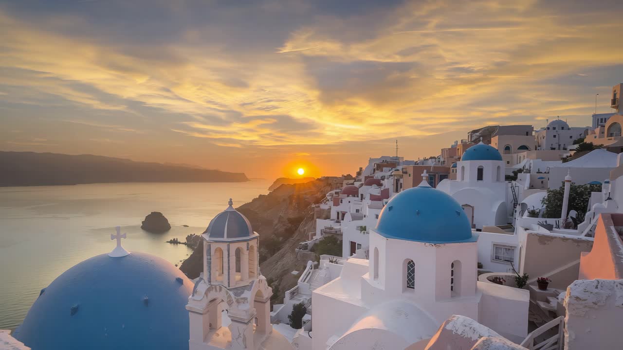 Sunset in Santorini, Greece with blue domed churches
