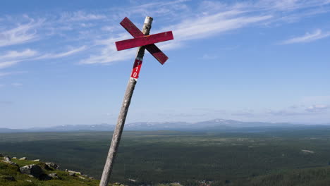 scenic landscape view with a snow scooter trail sign in sweden during summer