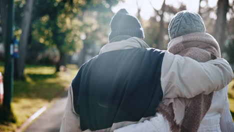 old couple, walking in park and winter with back