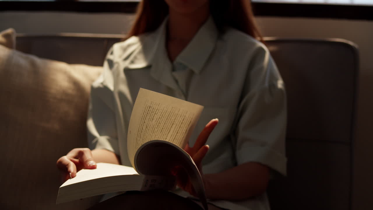 A serene moment captured as a person enjoys reading at home reflecting tranquility.