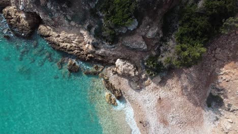 paradisiac hidden bay with crystal clear tuquoise water, sardinia, aerial static