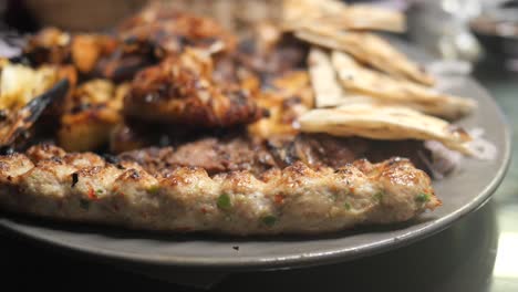 Seekh-kabab,-bread,-and-sauce-on-a-plate