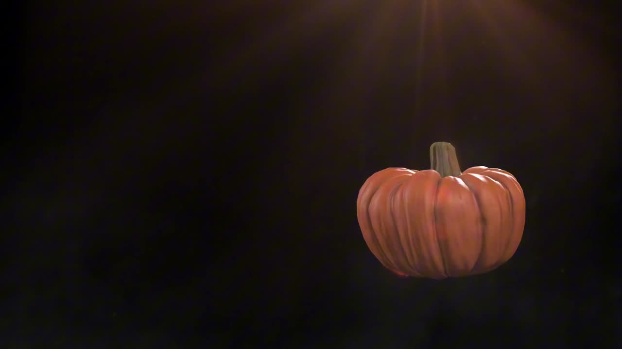 horror style background video with flying glowing smiling pumpkin on black background