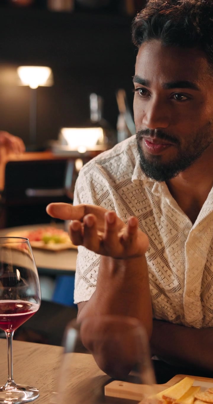 Young Man Talking and Gesturing During Dinner at a Restaurant