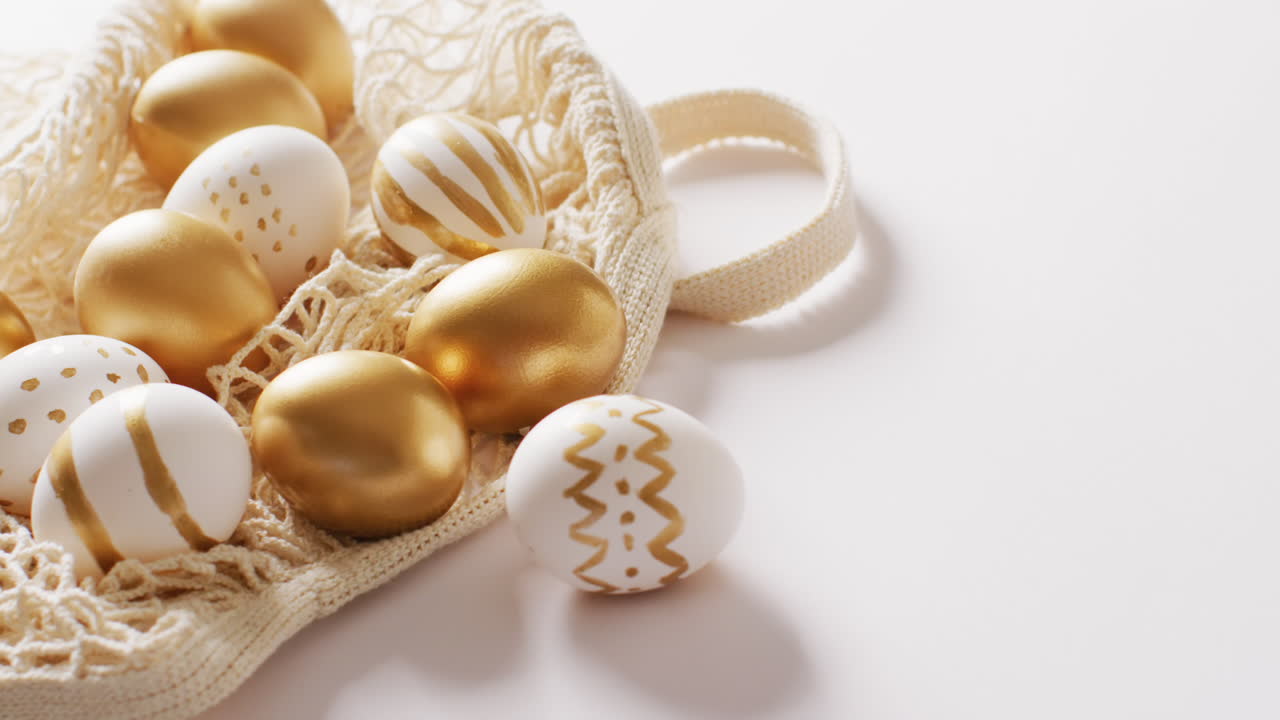 Bag with white and gold easter eggs on white background with copy space