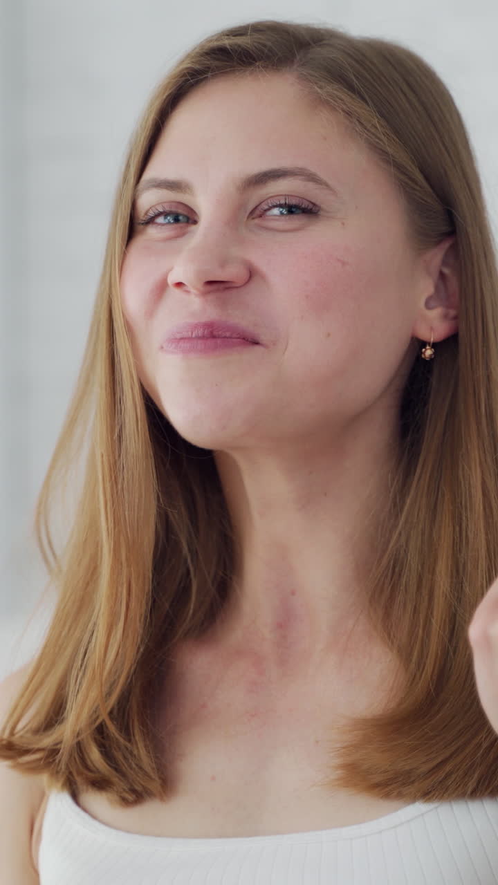 Woman having organic breakfast. Lifestyle portrait of young happy woman eating banana. Vertical video