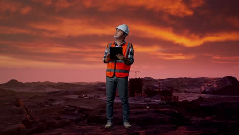 engineer inspecting construction site at sunset