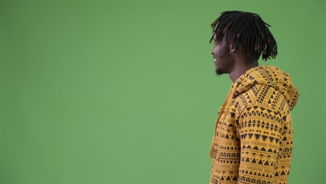 profile view of young happy handsome african man smiling
