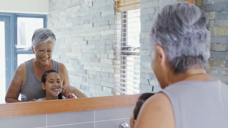 Grandmother-and-granddaughter-brushing-teeth-in-the-bathroom-4k