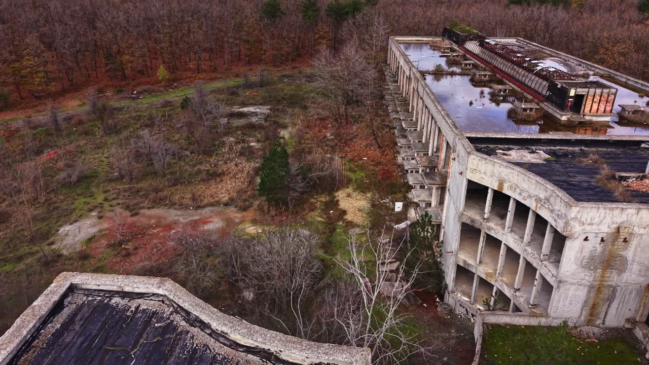 Abandoned structure seen from aerial view in a forested area