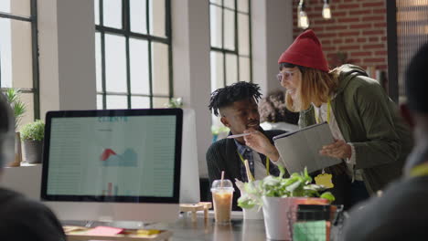 young business people working in startup office caucasian team leader woman pointing at tablet computer screen showing colleagues creative ideas training intern brainstorming discussing information