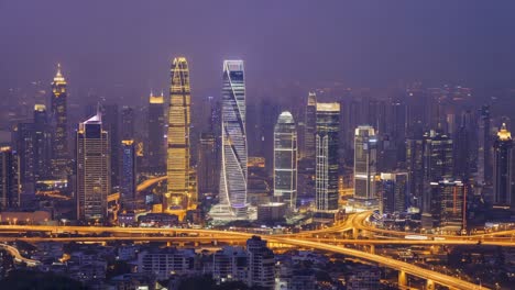 nighttime cityscape with illuminated skyscrapers and busy highways