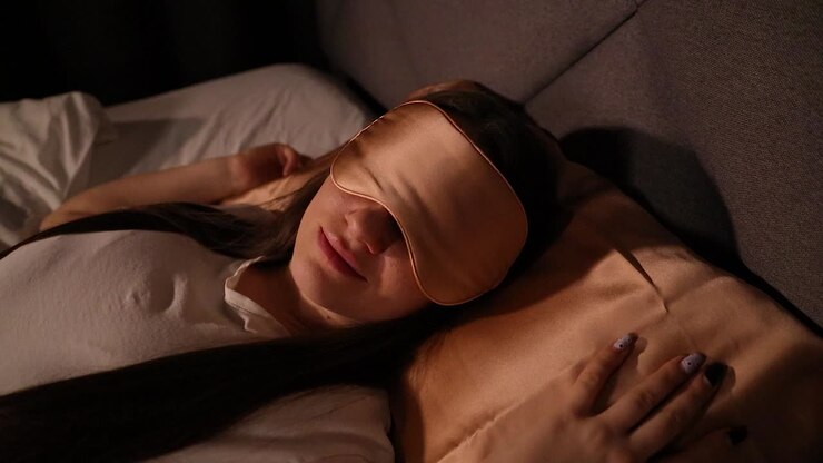 Happy and rested young beautiful woman waking up in the morning