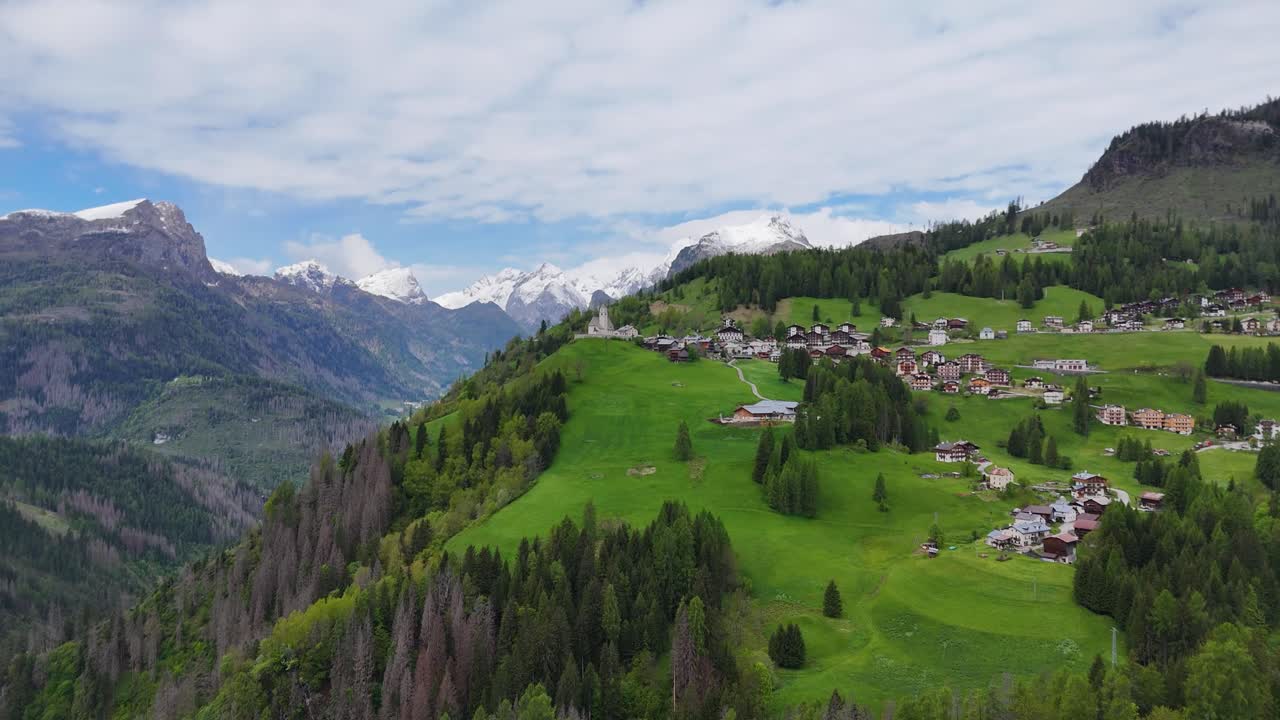 Landscape, forested hills and alpine buildings near Selva di Cadore