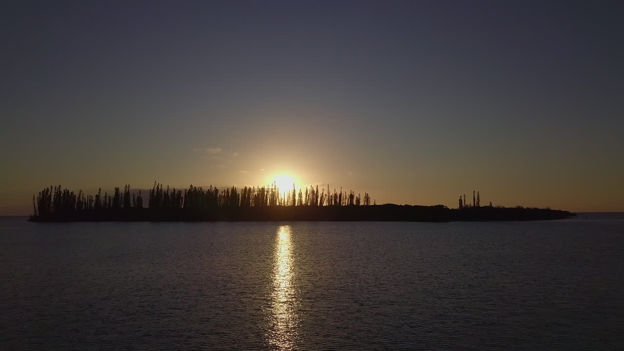 Aerial sunset over Isle of Pines, New Caledonia, dolly forward