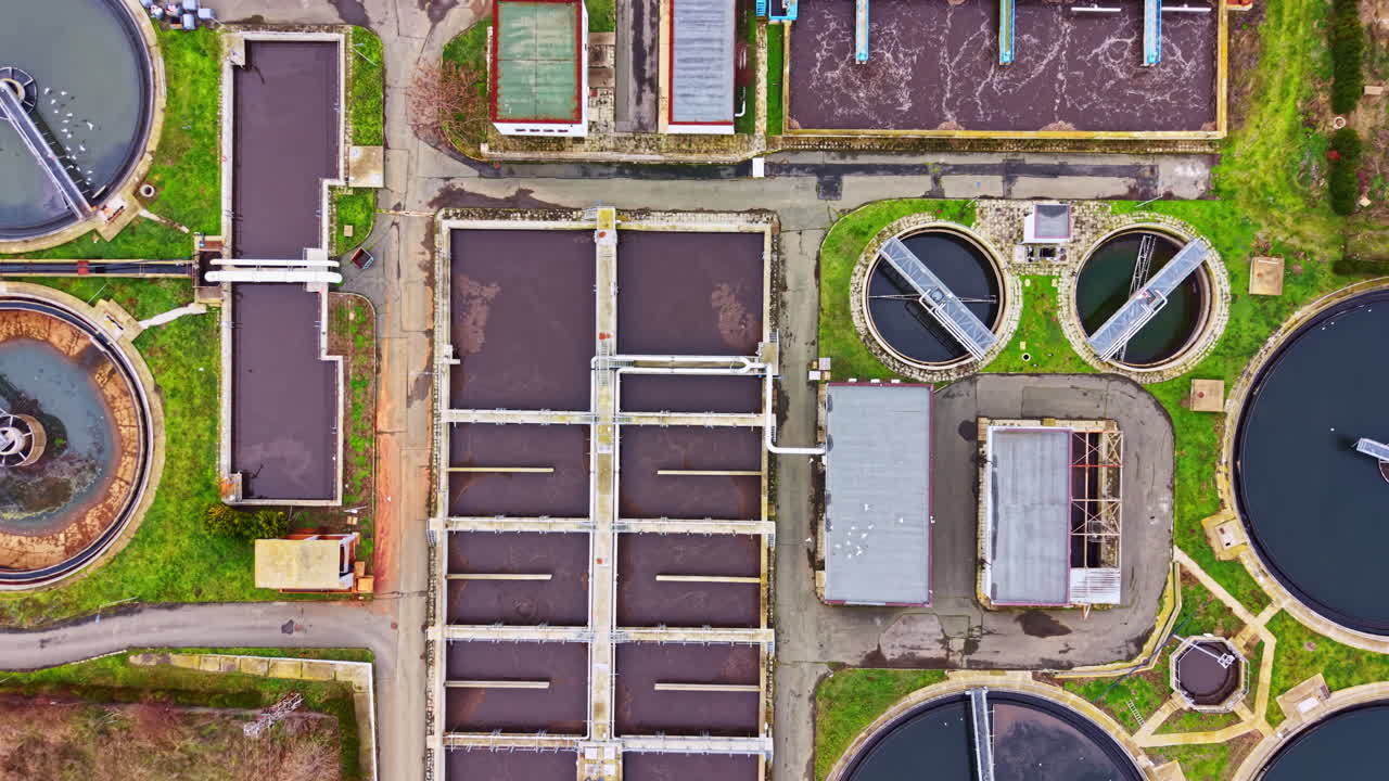 Water treatment facility in operation with tanks and pipelines showing various processes for cleaning water in a community setting