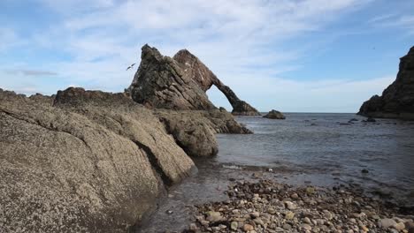 bow fiddle rock from the shoreline on a sunny calm day with rocks