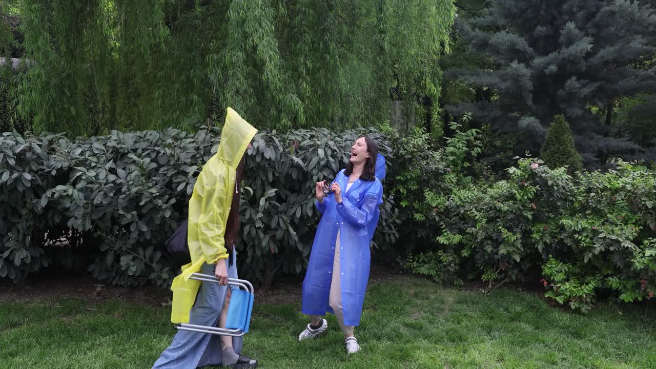 People in raincoats having fun outdoors