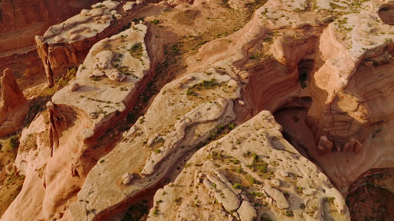 Amazing beautiful rocks formed by air erosion. Little green bushes growing on plain tops of mountains. Aerial view.