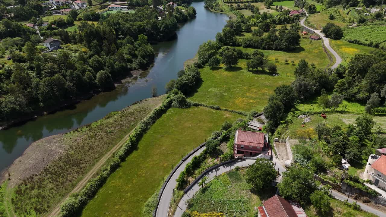 Aerial - scenic landscape of Mosteiro, Vieira do Minho, with a winding river and green countryside