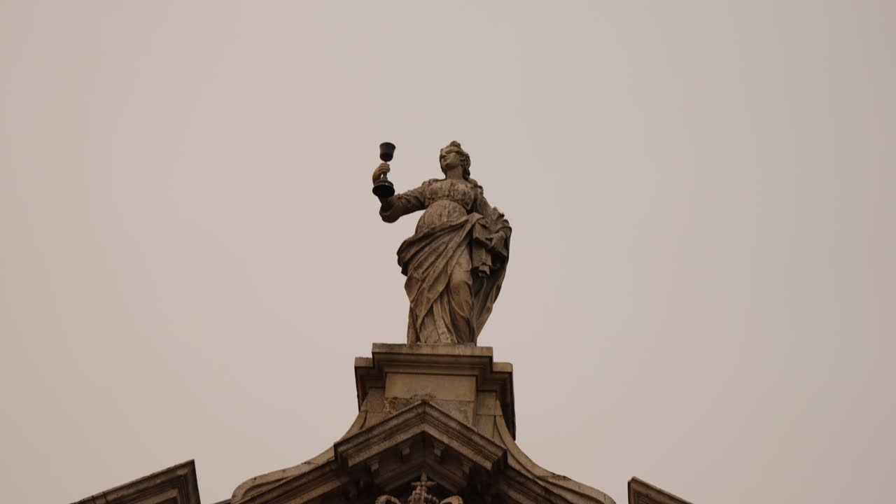 A Stone Statue Atop Historic Architecture In Porto, Portugal. Low Angle Shot
