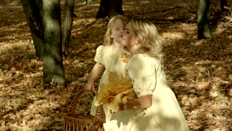 happy young mother with daughter in autumn park