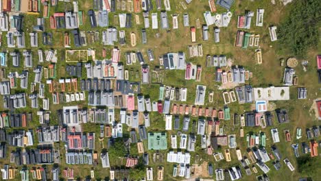 Slow-aerial-rising-drone-over-graveyard-with-many-graves-during-daytime