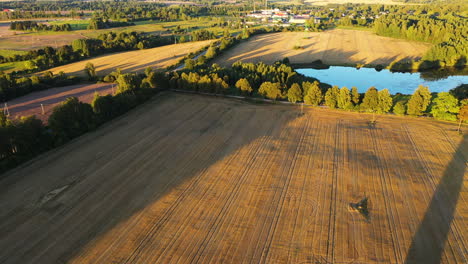 aerial view of countryside fields and lake on a sunny summer day
