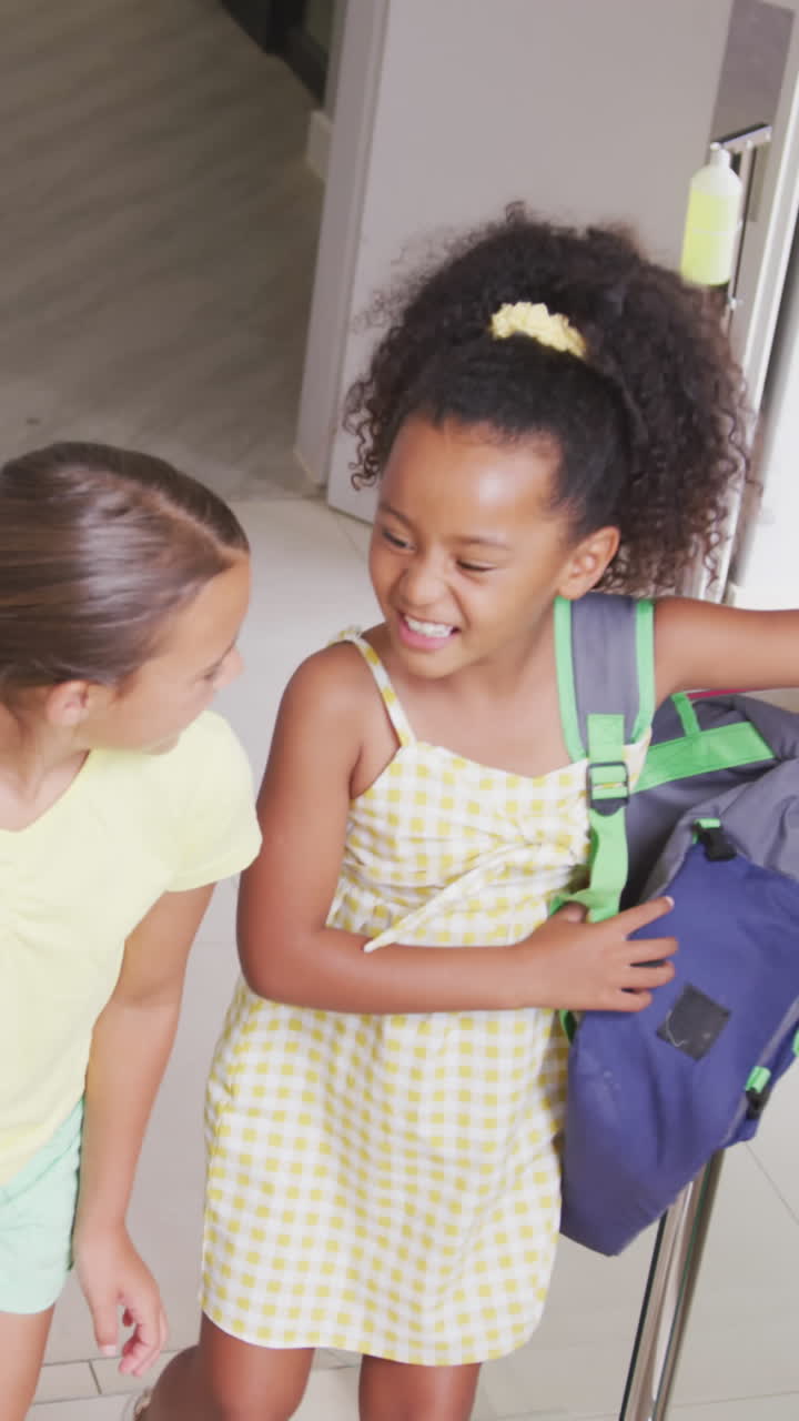 Video of happy diverse girls walking upstairs at school and talking