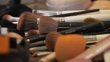 Rack-focus-shot-of-make-up-artists-messy-kit