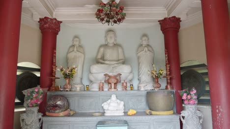 white marble buddha inside the prayer hall of temple in vietnam