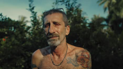 Man with Tattoo in Tropical Setting