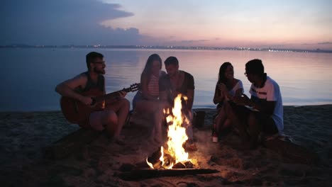 young people camping on lake