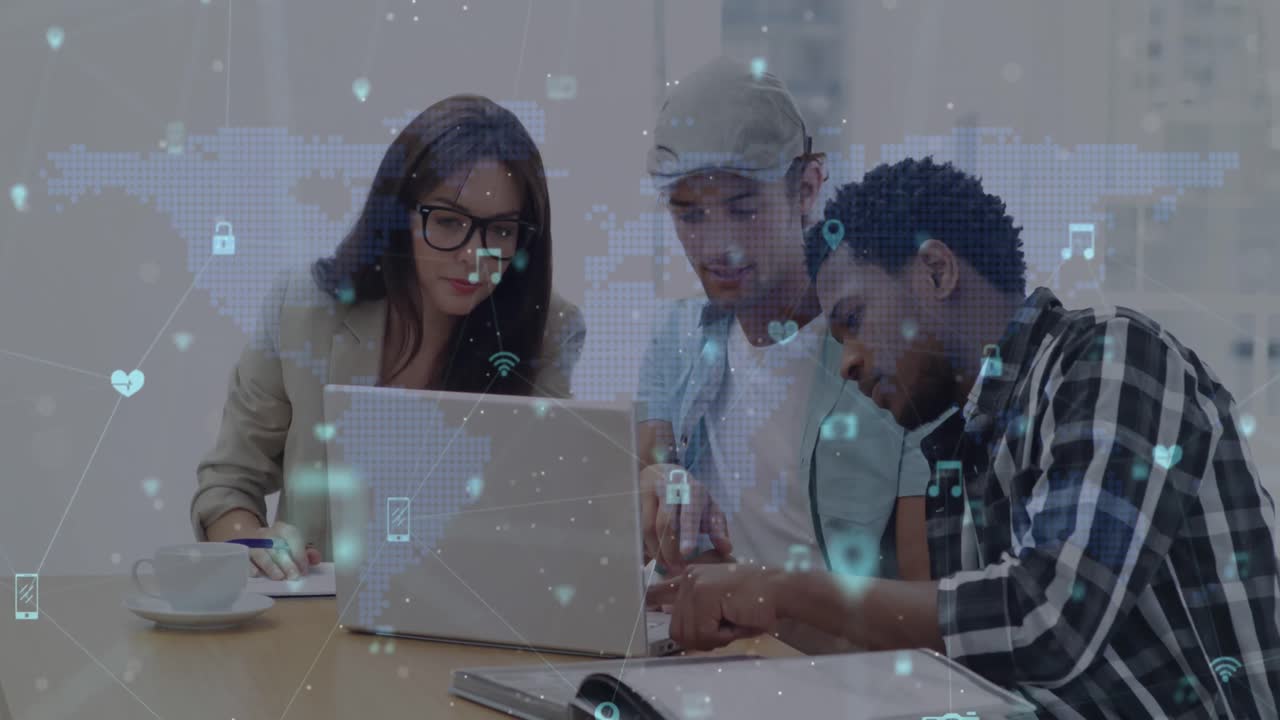 Network of digital icons against group of diverse office colleagues using laptop together at office