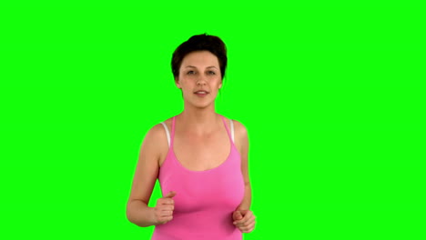 mujer en forma corriendo en la pantalla verde