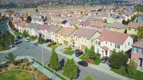 Aerial-drone-footage-flying-over-a-community-of-houses-from-a-park