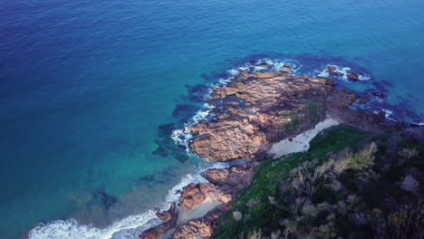 beautiful rocky coastline with waves breaking on shore, tasman sea, aerial