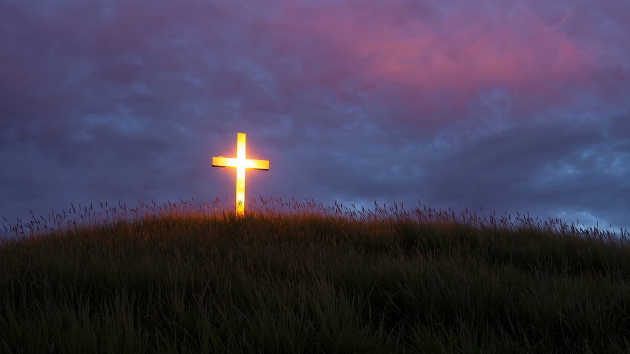 Illuminated Cross on a Hill at Sunrise/Sunset