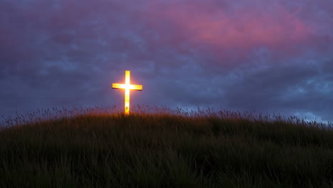 illuminated cross on a hill at sunrise/sunset