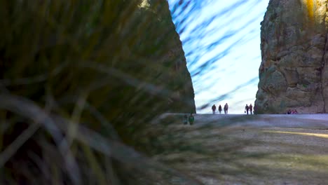 people walking through a rocky canyon