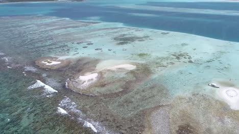 moving-turn aerial view  beach cay  and-shallow-turquoise waters in the caribbean sea in  sebastopol los-roques national park venezuela.