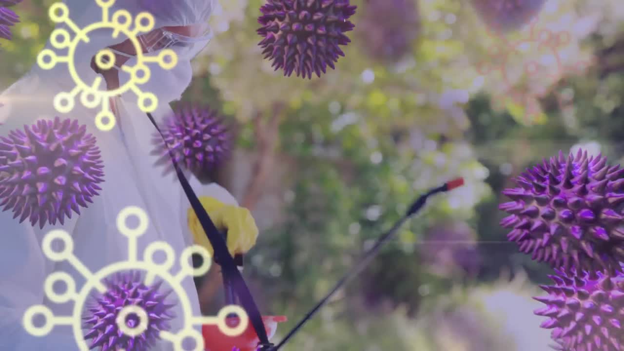 Animation of COVID-19 macro cells over a Caucasian man in protective suit and bacteria icons