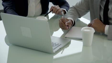 cropped shot of managers working with laptop