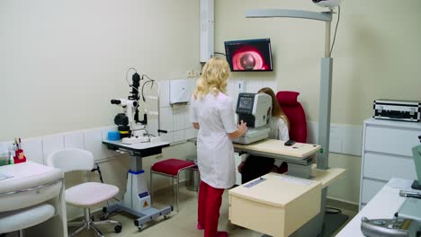 contemporary ophthalmology clinic. eye doctor testing woman eyesight. female optometrist examining patient's eyes on a modern medical equipment.