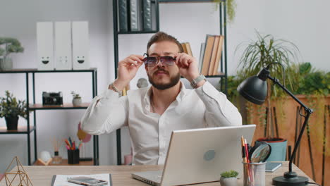 Money-cash-dollar-rain-falling-on-adult-office-business-man-celebrating-success-winning-career-grow